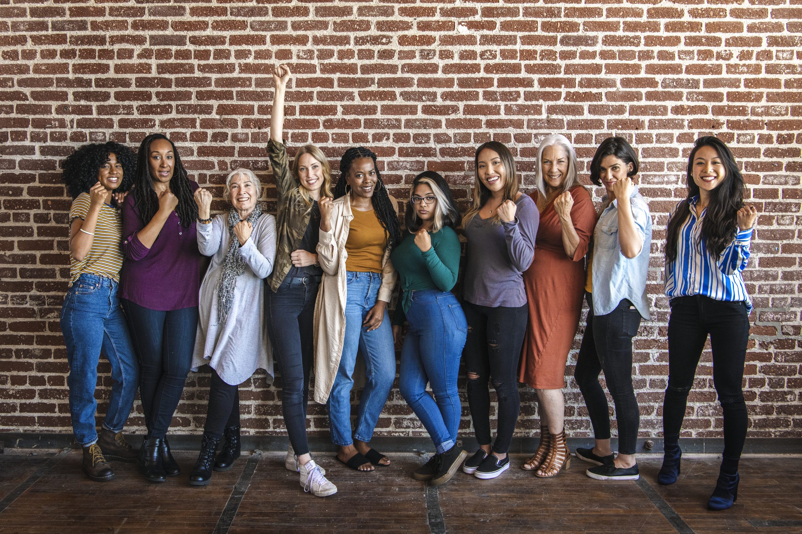 Powerful women standing together with clenched fists