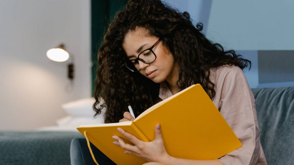 Woman Writing In Journal